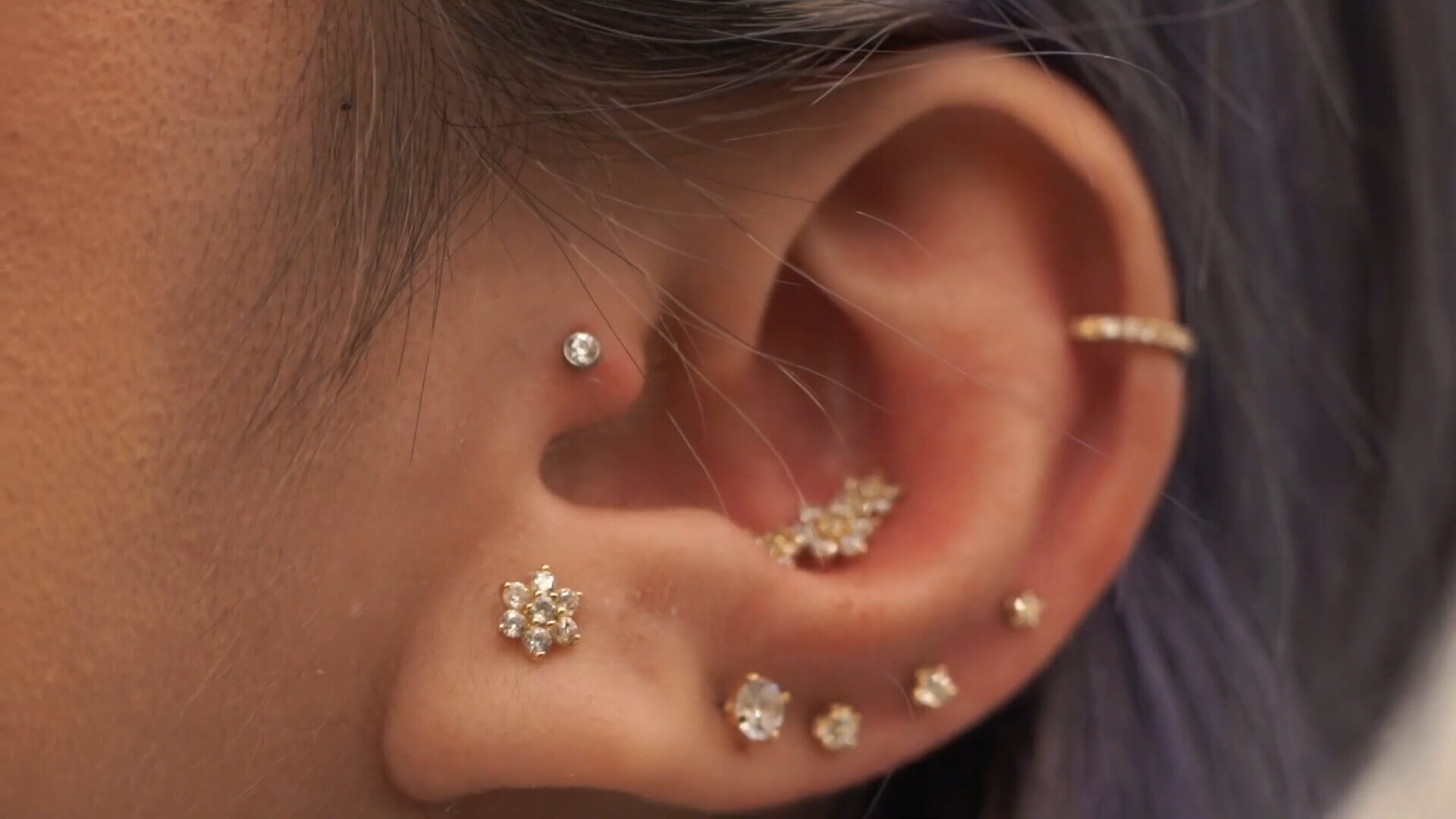 Ear with various piercings